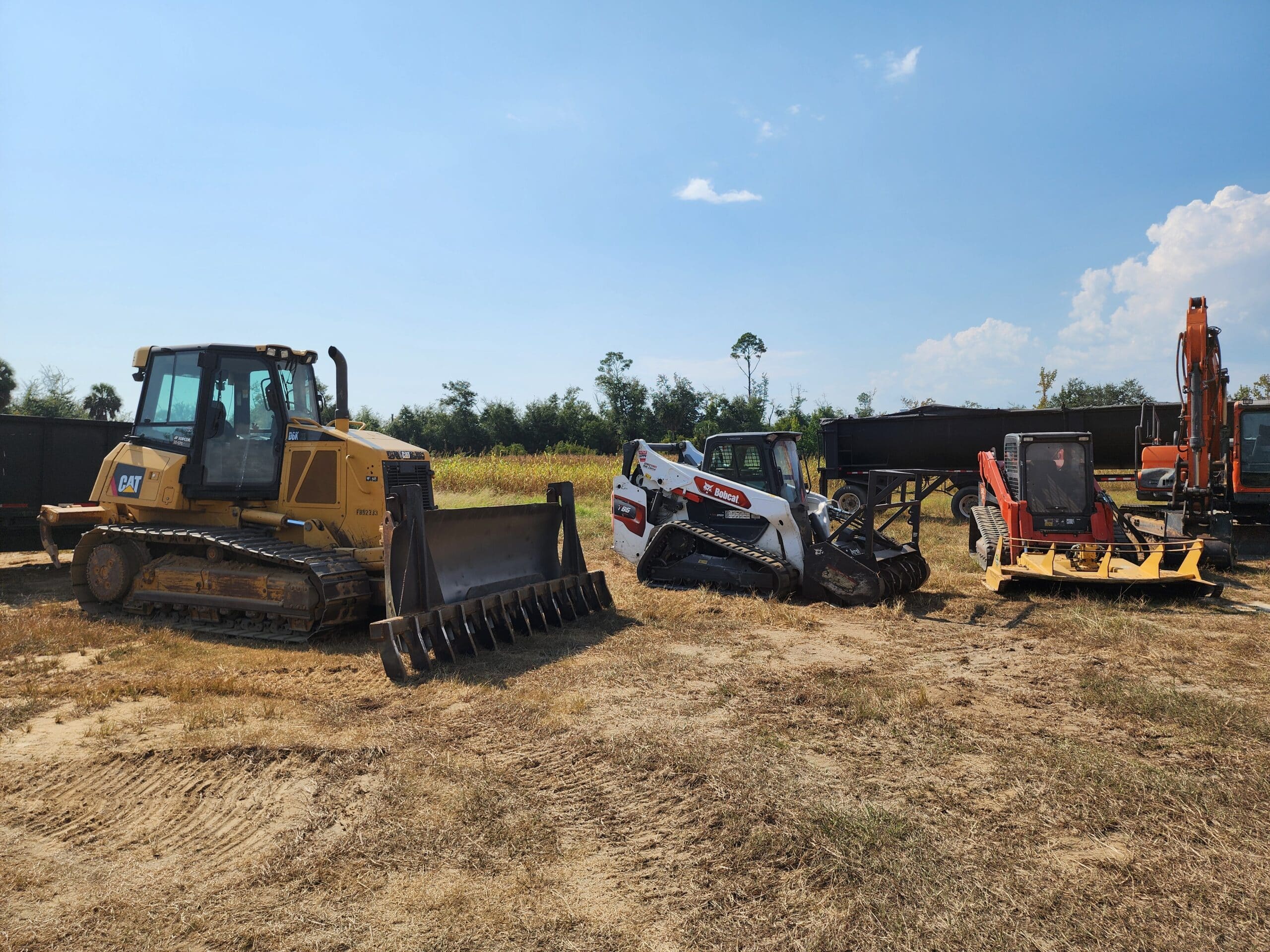 Panhandle Development of Bay County Florida based in Panama City shows a range of heavy duty construction machines and work vehicles used for digging debris hauling land clearing and demolition